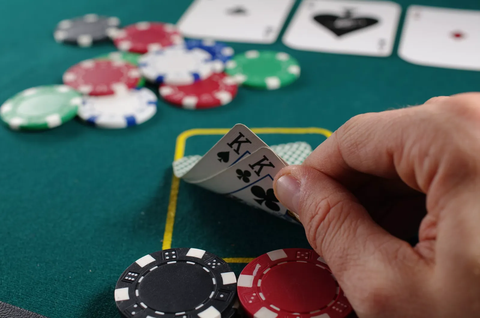 A close-up of a strategic card game on a green table